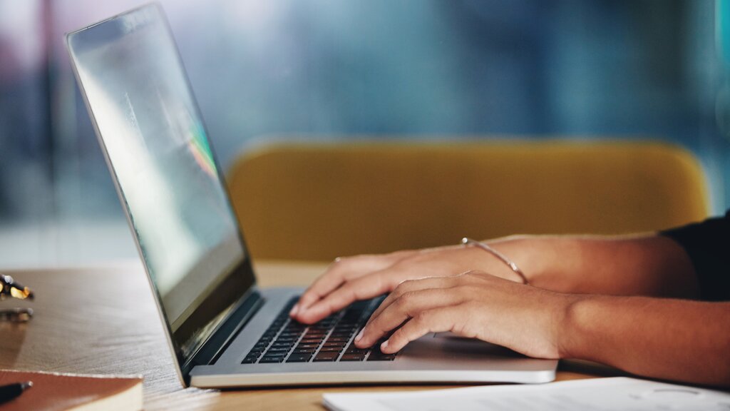 Person using a laptop to research businesses online before making contact